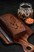 From above view of a carrot cake next to the ingredients on a rustic background