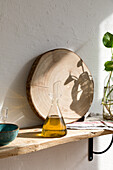 Glass jar with natural aromatic olive oil placed on shelf in home kitchen
