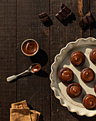 From above salted caramel chocolate cookies on ceramic plate on wooden table background