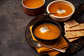 Delicious plates of creamy pumpkin soup seen from above