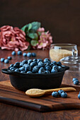 Detail of blueberries in a bowl on the wooden table