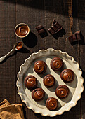 From above salted caramel chocolate cookies on ceramic plate on wooden table background