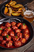 Closeup viewed from above of a plate of meatloaf with tomato