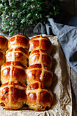 Ernte frisch gebackene Hot Cross Brötchen auf Backblech