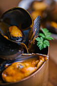 Delectable mussels with herbs in metal saucepan