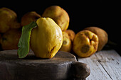 Fresh whole sour yellow lemon on white wooden background