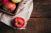 Fresh red apples in a box on table