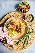 From above baked potato in jacket with bacon and cabbage served in plate