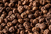 Background top view of heap made from tiger nut arranged on surface