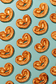 Top view of delicious baked elephant ear cookies placed in lines on colorful surface