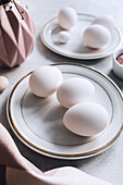 Still life of beautiful painted Easter eggs over white table background