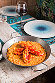 High angle of palatable rice with red prawns served in plate on table in Asian restaurant