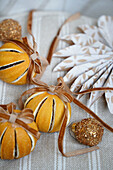 Christmas decoration made from dried oranges with brown bows and a paper star