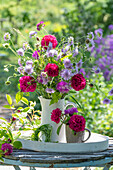 Bouquet of widow flower (Scabiosa), knapweed (Centaurea), rose 'Vivid' (Rosa bourbonica) and globe thistle (Echinops) in a jug, close-up