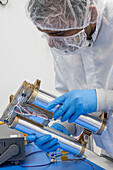 Lunar rover scientist examining hydrogen-seeking instrument