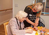Care home resident taking part in activity