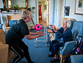 Care home resident taking part in exercise class