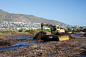Mechanical digger reshaping wetlands