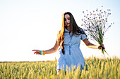 Woman picking flowers in a field