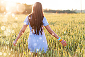 Woman walking through a wheat field