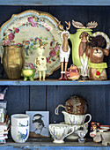 Shelf with various animal figurines, porcelain and decorative items