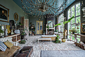 Vintage room with stone floor, crystal chandelier and large windows