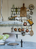 Vintage kitchen utensils on a wall bracket