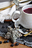 Mug with mulled wine and Christmas star made of lichen