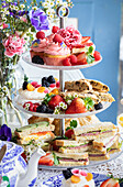 High tea with sweet pastries and sandwiches