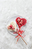 Heart-shaped meringue lollipops
