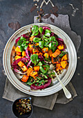 Salad with baked pumpkin, leaf lettuce and cocoa dressing