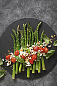 Green asparagus with roasted tomatoes, feta and pine nuts