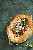 Asparagus and tomato quiche with ricotta filling and pine nuts in filo pastry