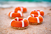 Motif biscuits in the shape of lifebuoys on the beach
