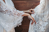 Close-up of wedding dress with lace appliqués and tulle fabric