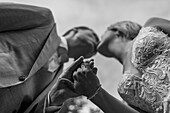 Bride and groom hold hands during the wedding ceremony