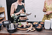 Cheese platter and desserts at a garden party with guests