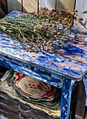 Bouquet of dried flowers on blue painted vintage wooden stool