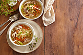 Chicken soup with vegetables, carrots, celery and fresh herbs