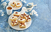 Christmas biscuits with walnut filling and almond decoration