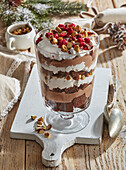 Layered dessert with chocolate, nuts and raspberries for Christmas