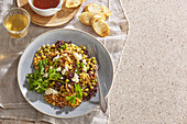 Lentil and rice salad with peas, nuts and feta cheese