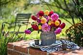 Colorful bouquet with dahlias (Dahlia) on brick wall