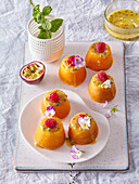 Passion fruit mini cake with flowers and fruit topping