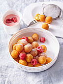 Mini churros with raspberries and liqueur cream sauce