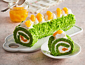 Spinach sponge roll with cream cheese filling and mandarins