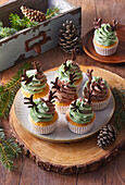 Camouflage pattern cupcakes with cream and chocolate antlers