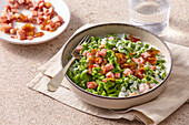 Spinach spaetzle with blue cheese sauce and bacon cubes