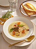 Fish soup with carrots and croutons