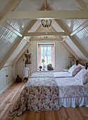 Attic room with double bed, floral ceiling and dressmaker's dummy